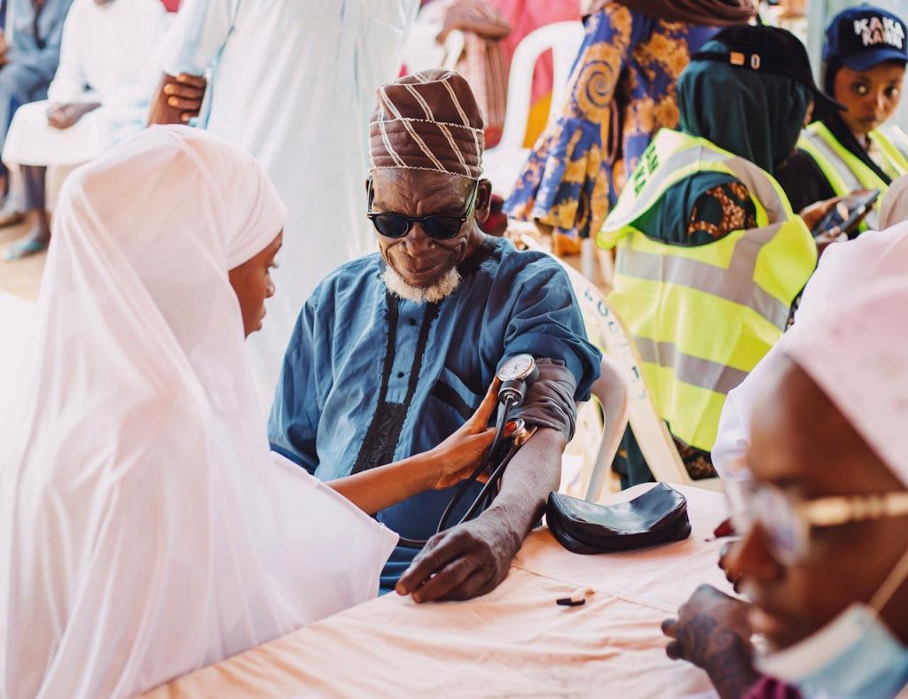 pexels photo 33127693 Elderly man receives medical care during community health outreach in Kaduna, Nigeria.